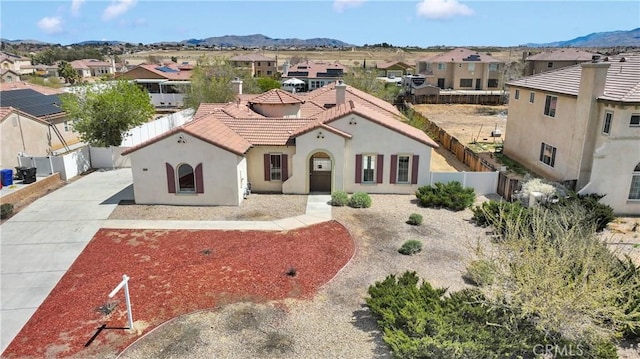 12573 Cabazon Ct, Apple Valley, CA 92308 - mediterranean / spanish house with a tile roof, stucco siding, fence, a residential view, and a mountain view