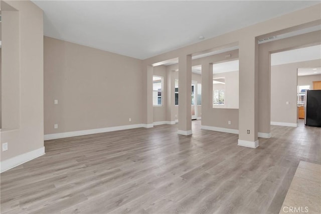 12573 Cabazon Ct, Apple Valley, CA 92308 - unfurnished living room featuring baseboards and light wood-style floors