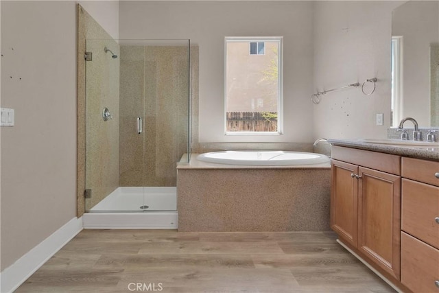 12573 Cabazon Ct, Apple Valley, CA 92308 - full bathroom featuring a stall shower, a bath, wood finished floors, and vanity