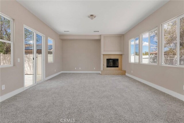 12573 Cabazon Ct, Apple Valley, CA 92308 - unfurnished living room featuring carpet floors, a glass covered fireplace, baseboards, and visible vents