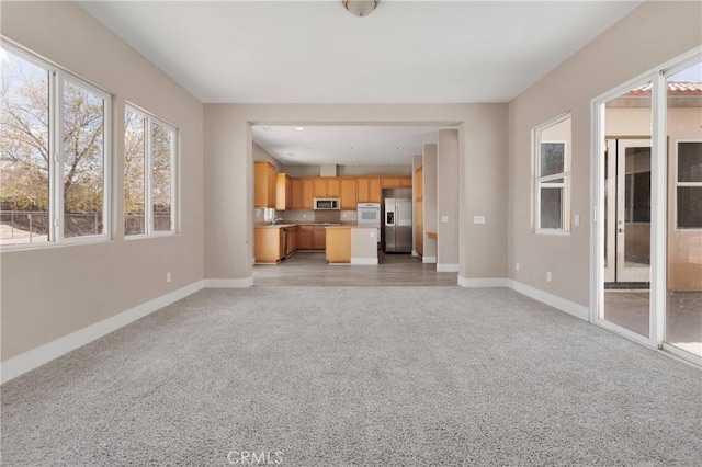 12573 Cabazon Ct, Apple Valley, CA 92308 - unfurnished living room with light carpet and baseboards