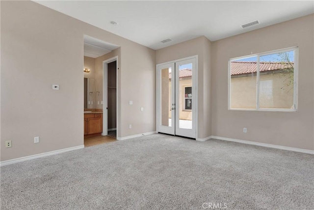 12573 Cabazon Ct, Apple Valley, CA 92308 - unfurnished room with french doors, baseboards, light colored carpet, and visible vents