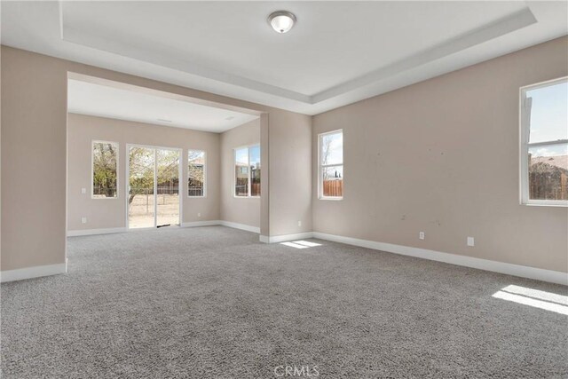 12573 Cabazon Ct, Apple Valley, CA 92308 - spare room with baseboards, a tray ceiling, and carpet