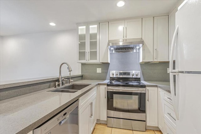 kitchen with appliances with stainless steel finishes, white cabinets, and sink