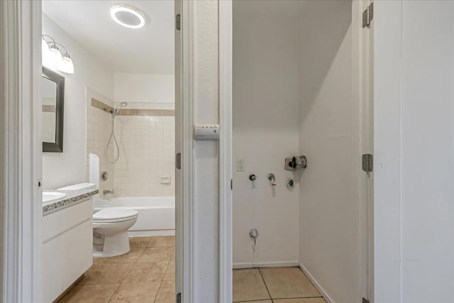 full bathroom featuring tiled shower / bath, tile patterned flooring, vanity, and toilet