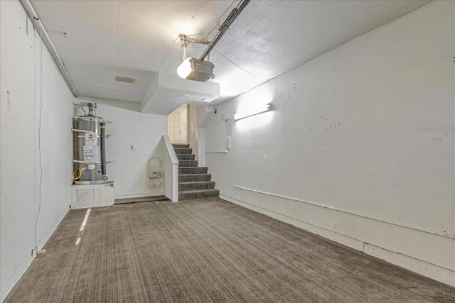 basement featuring carpet flooring and strapped water heater