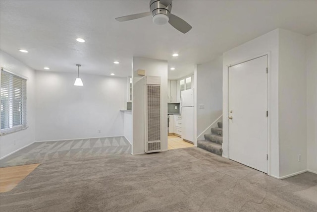 unfurnished room featuring light carpet and ceiling fan