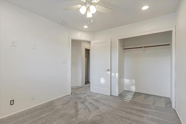 unfurnished bedroom featuring ceiling fan, a closet, and light carpet