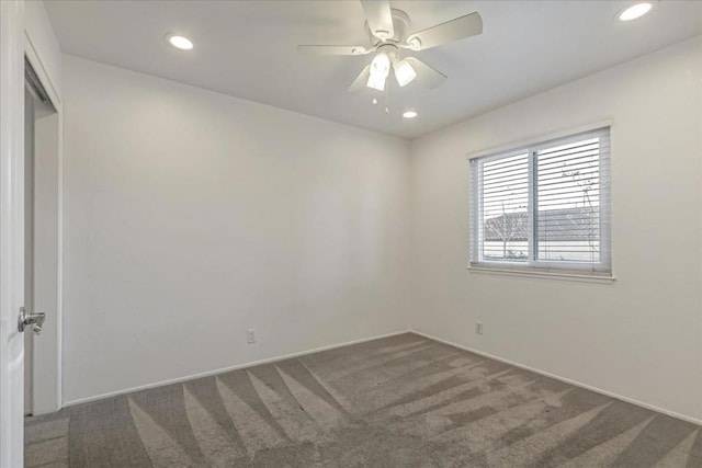 carpeted spare room with ceiling fan