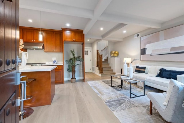 living room with beam ceiling, light hardwood / wood-style floors, and coffered ceiling