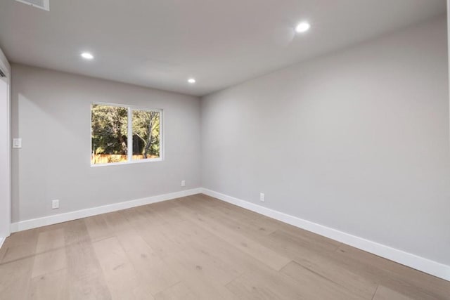 unfurnished room with light hardwood / wood-style flooring