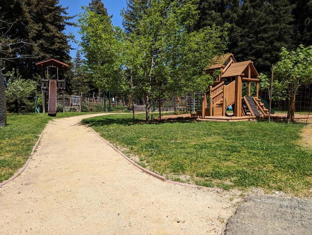 view of playground with a lawn