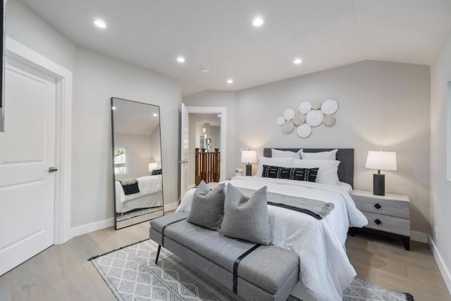 bedroom featuring lofted ceiling and light wood-type flooring