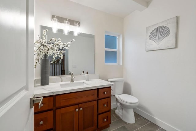 bathroom featuring toilet, vanity, and tile patterned floors