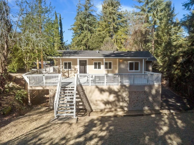 back of property with a wooden deck