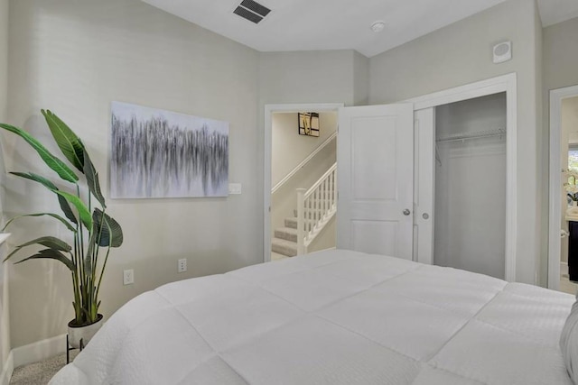 carpeted bedroom with a closet