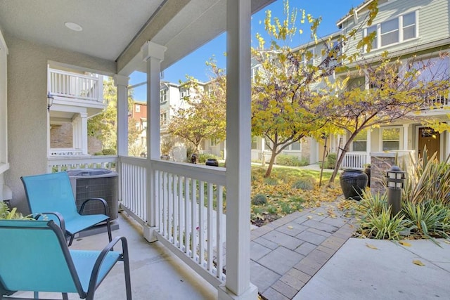 balcony featuring covered porch and central AC