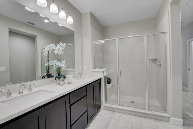 bathroom with tile patterned floors, vanity, and an enclosed shower