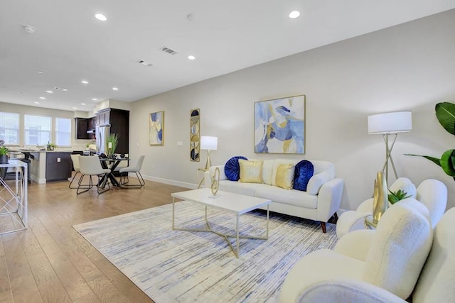 living room with light hardwood / wood-style flooring