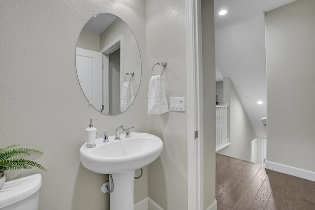 bathroom with hardwood / wood-style floors and toilet