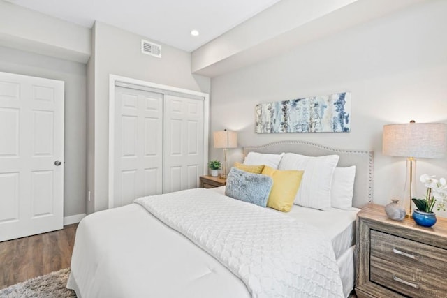 bedroom with hardwood / wood-style flooring and a closet