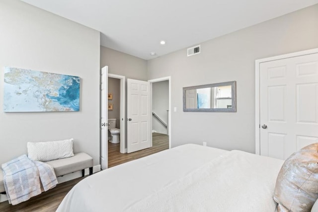 bedroom featuring dark hardwood / wood-style floors and connected bathroom