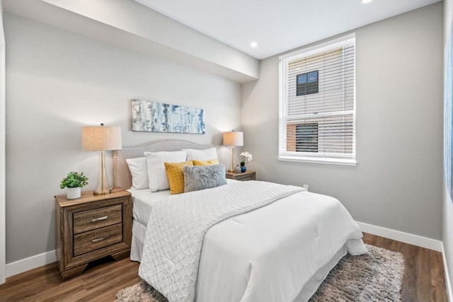 bedroom with dark hardwood / wood-style floors