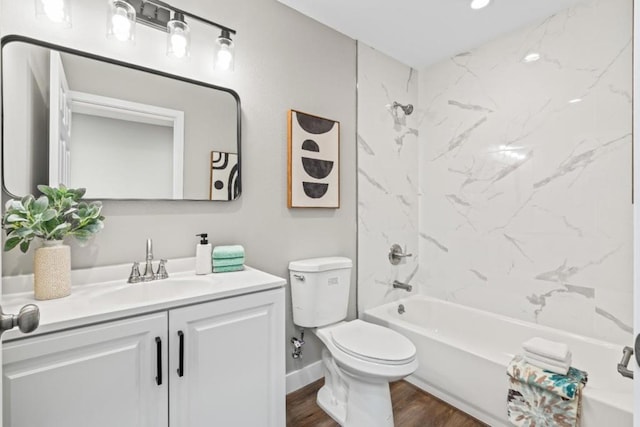 full bathroom featuring vanity, toilet, wood-type flooring, and tiled shower / bath