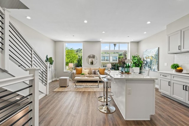 kitchen with light hardwood / wood-style floors, a center island, and white cabinetry