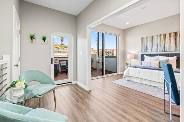 bedroom with access to outside and light hardwood / wood-style floors