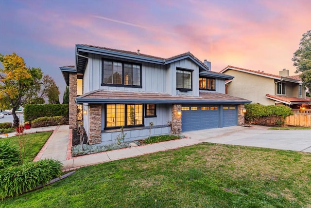 view of front of home featuring a yard and a garage