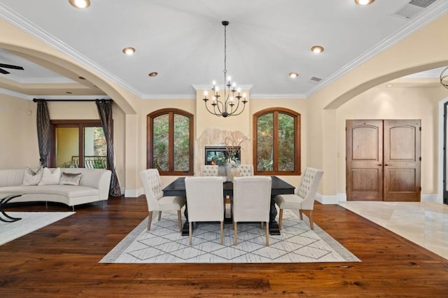 dining room with crown molding, plenty of natural light, and light wood-type flooring