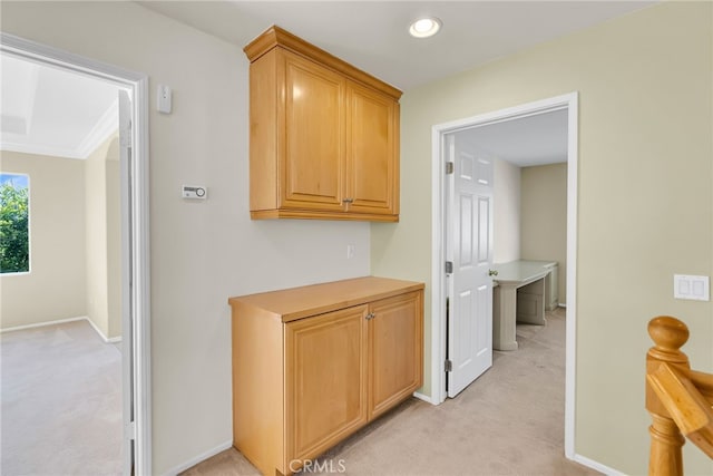 hallway featuring light colored carpet