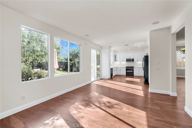 unfurnished living room with hardwood / wood-style floors