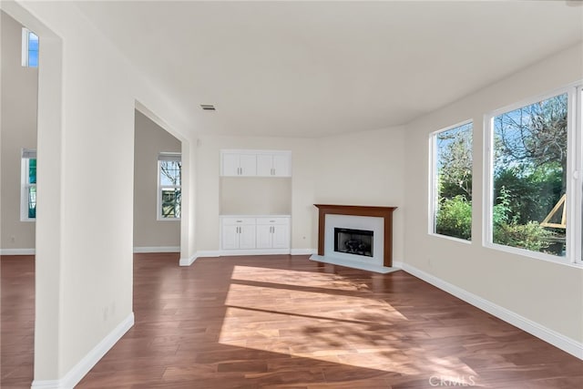 unfurnished living room featuring dark hardwood / wood-style floors