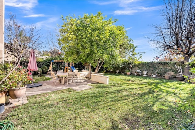 view of yard featuring a playground and a patio