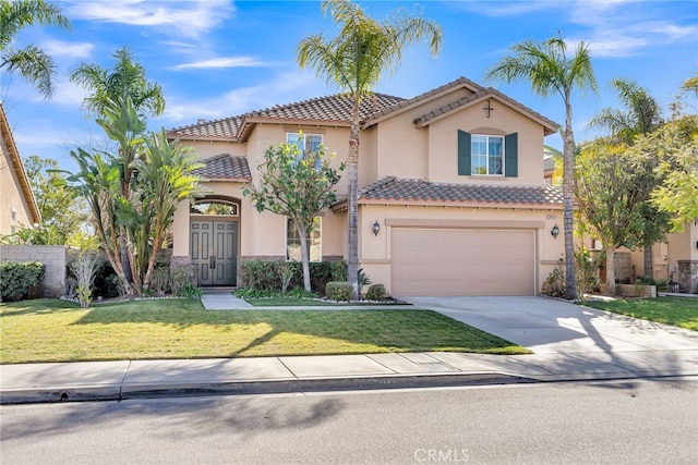 mediterranean / spanish-style house with a front yard and a garage