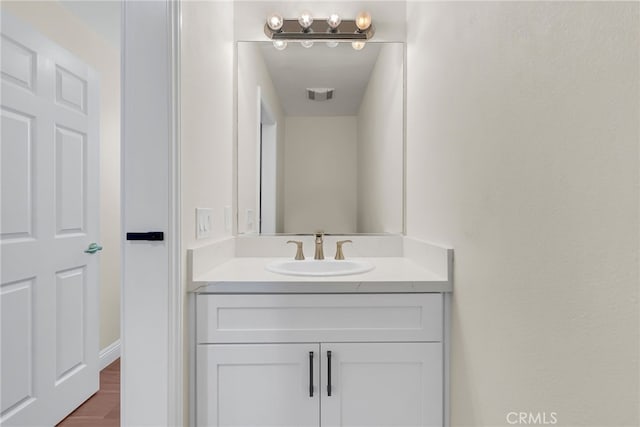 bathroom with hardwood / wood-style floors and vanity