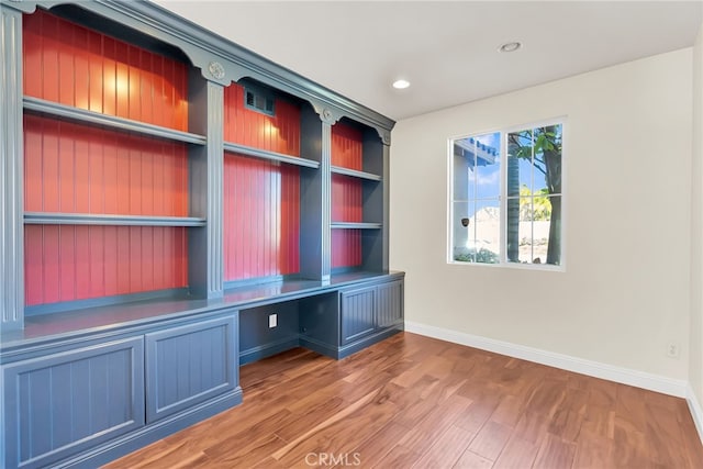 mudroom featuring hardwood / wood-style flooring and built in desk