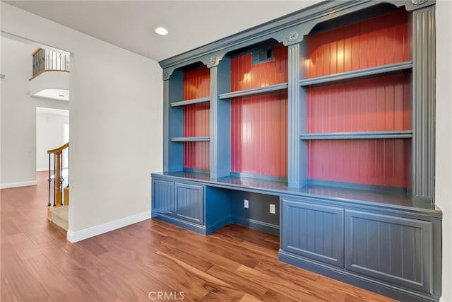 mudroom featuring hardwood / wood-style floors and built in desk