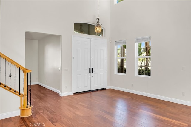 foyer with hardwood / wood-style flooring and a high ceiling