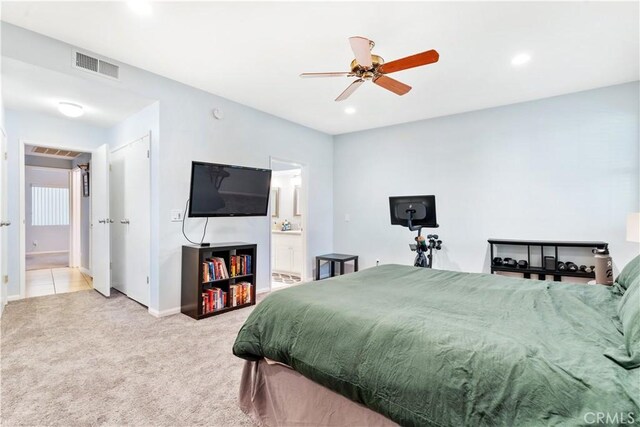 carpeted bedroom featuring connected bathroom and ceiling fan