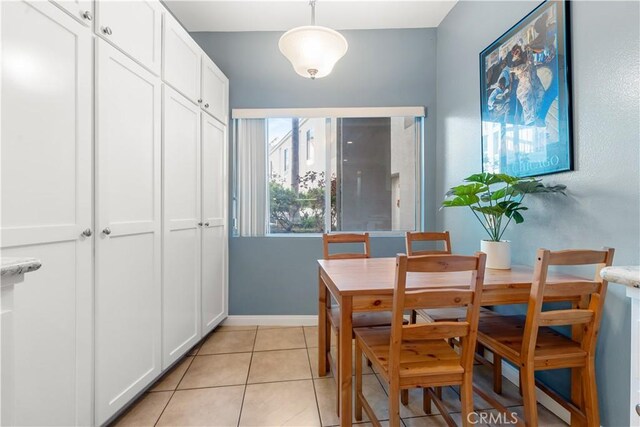 dining space featuring light tile patterned floors