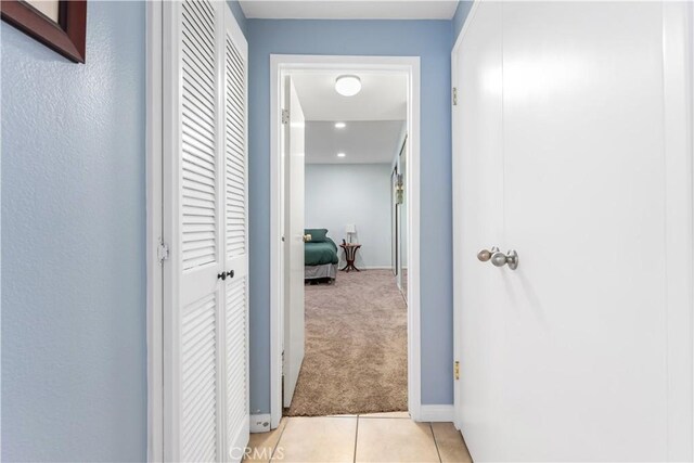 corridor featuring light colored carpet