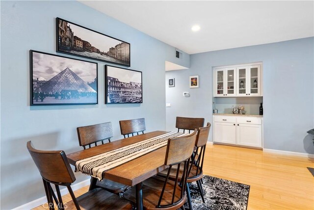 dining space with light hardwood / wood-style floors