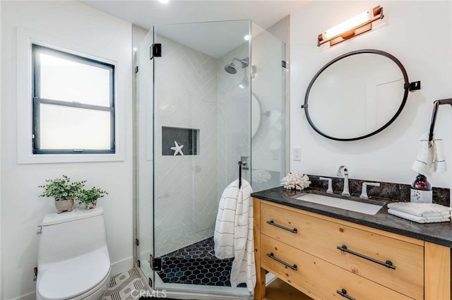 bathroom with vanity, toilet, and walk in shower