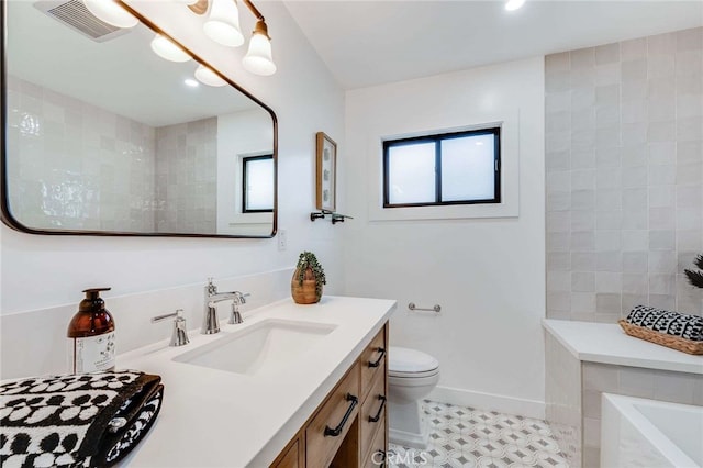 bathroom featuring tile patterned floors, vanity, and toilet