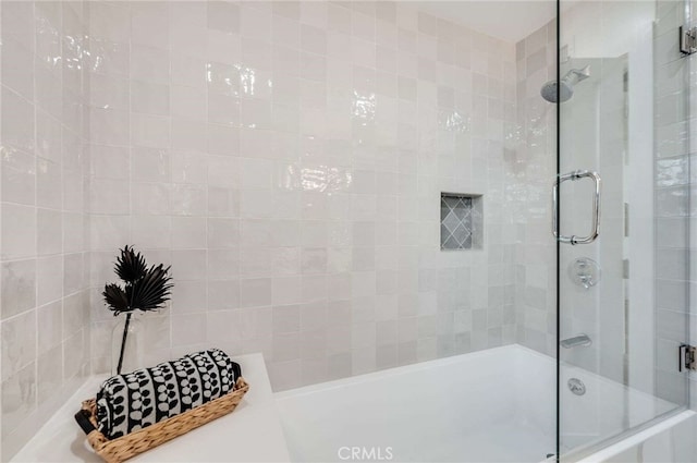 bathroom with shower / bath combination with glass door