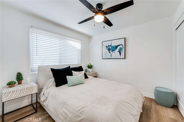 bedroom featuring ceiling fan and hardwood / wood-style flooring