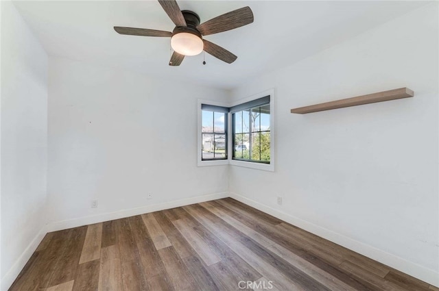 empty room featuring ceiling fan and hardwood / wood-style flooring